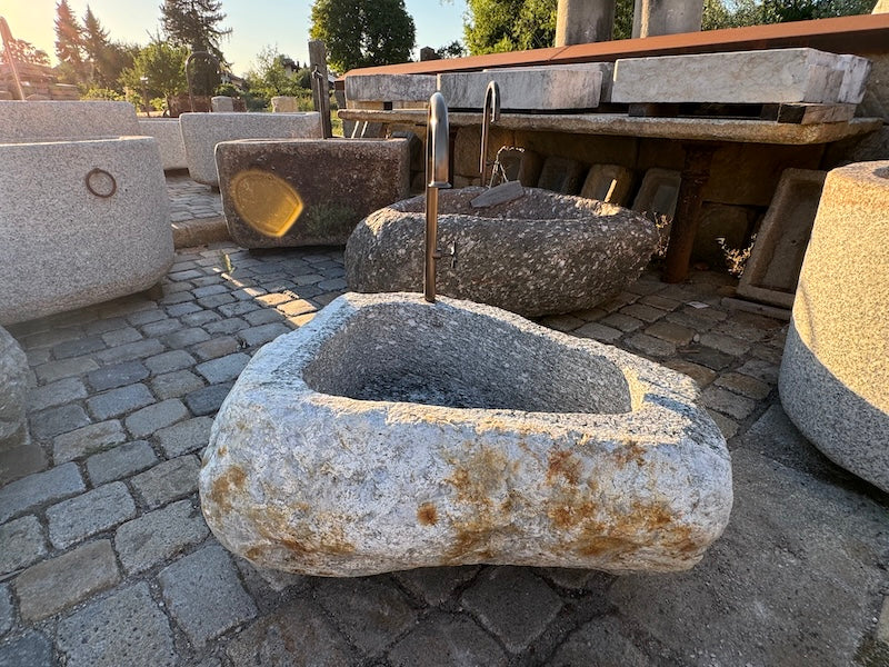 Findlingsbrunnen mit rostfarbenen Stellen