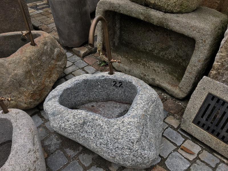 Kleiner Findlingsbrunnen mit farblichen Einschlüssen Seitenansicht